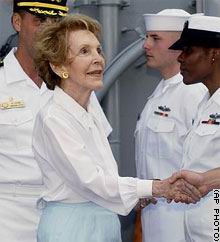 Nancy Reagan shakes hands with crew members aboard the USS Ronald Reagan during preparations for the commissioning ceremony July 12, 2003 - "Man the ship and bring her alive," said former first lady Nancy Reagan, who was on hand for the ceremony at Naval Station Norfolk. 